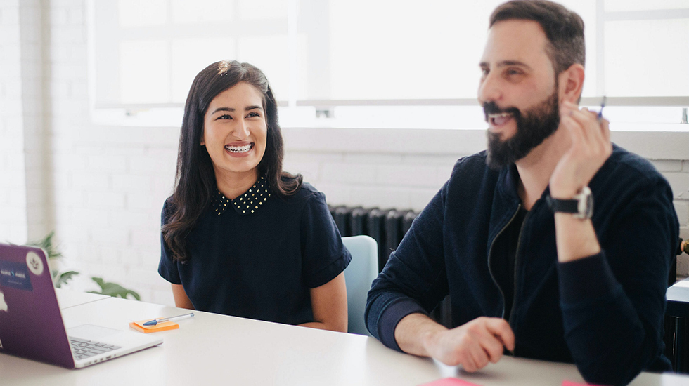 Two employees laughing